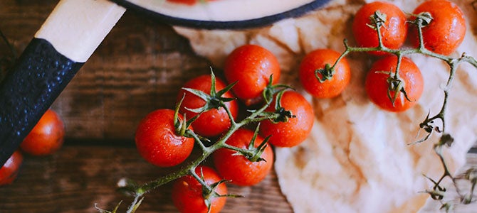 Improved Health & Wellness with the Pharmanex BioPhotonic Scanner Fresh tomatoes on a vine spread out across a countertop.